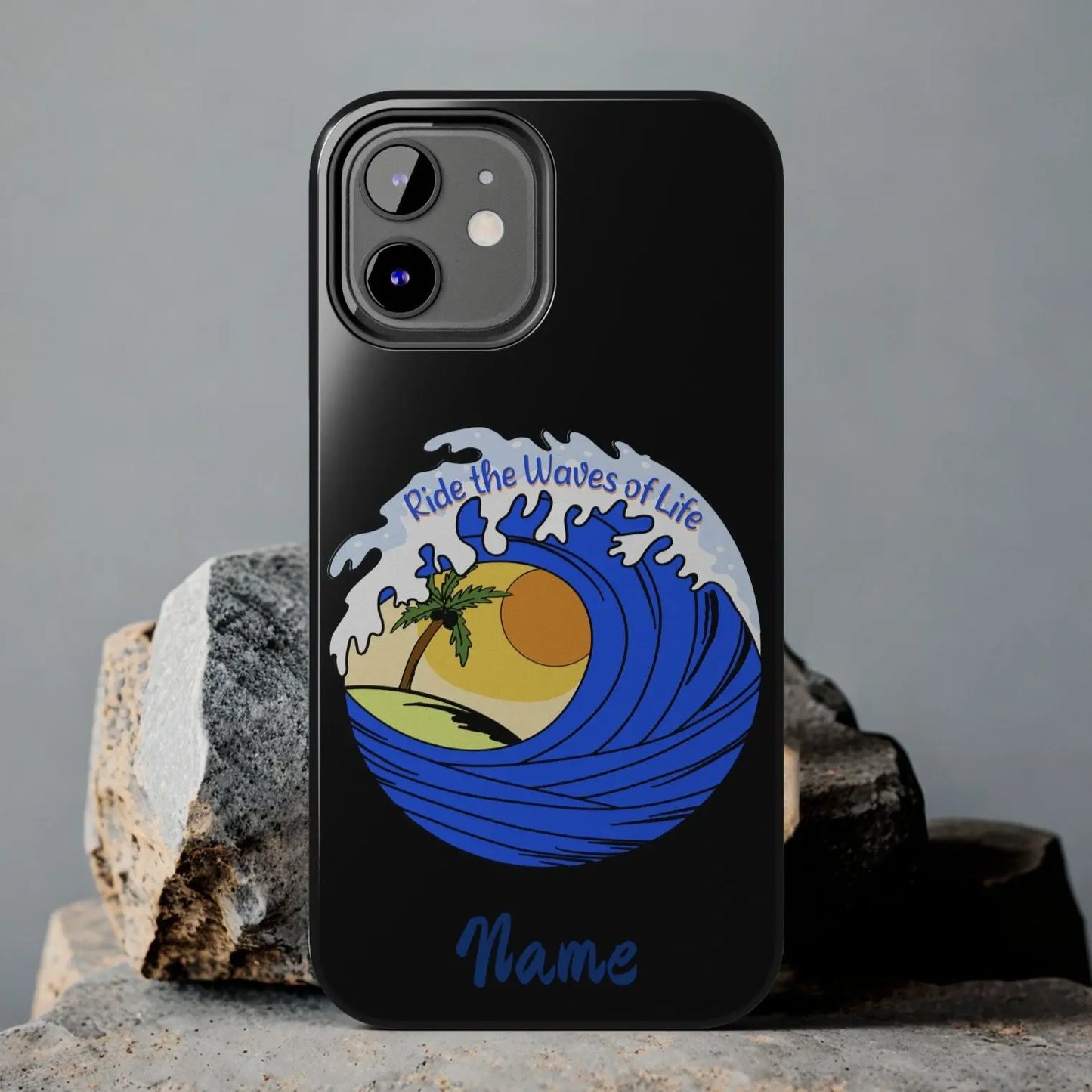 Black iPhone 12 Case with wave with sun and palm tree in the middle that says Ride the Waves of Life.