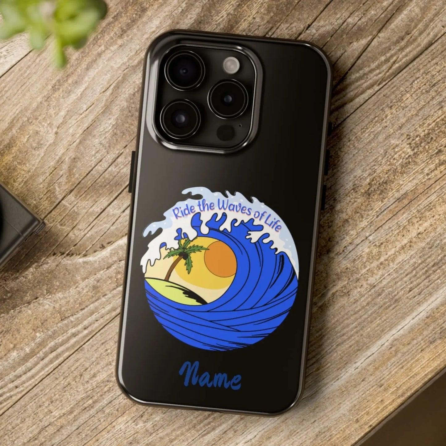 Black iPhone 15 Pro Max Case with wave with sun and palm tree in the middle that says Ride the Waves of Life.