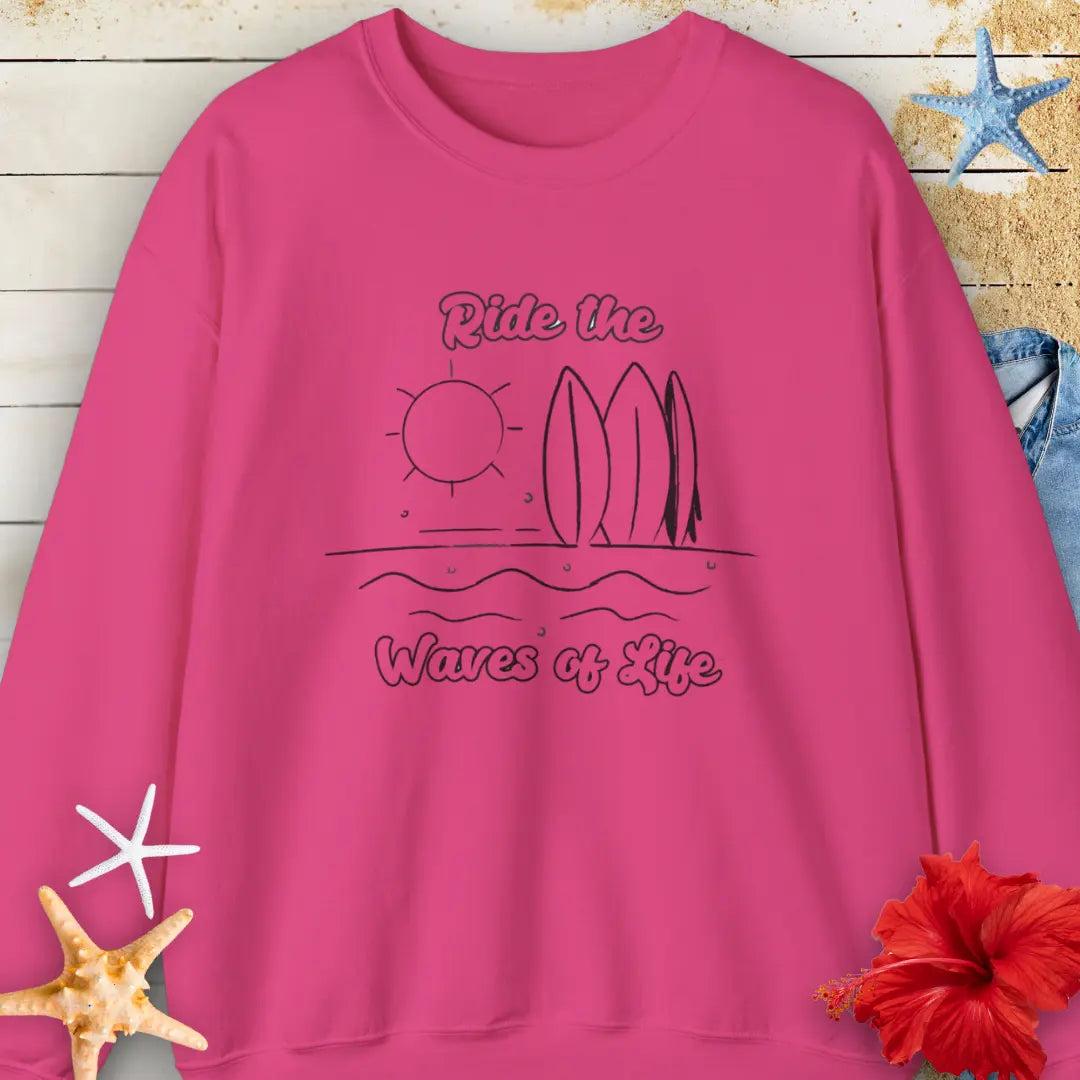Our Ride the Waves of Life Sweatshirt in Heliconia with Surfboards and the sun line art with the phrase ide the Waves of Life. Perfect for any surfing enthusiast.