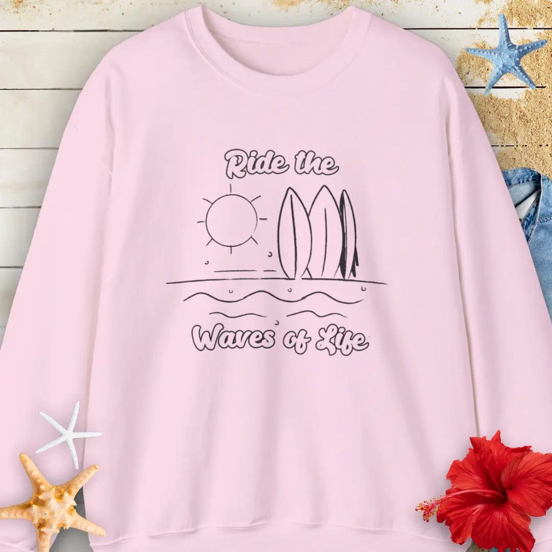 Our Ride the Waves of Life Sweatshirt in Light Pink with Surfboards and the sun line art with the phrase ide the Waves of Life. Perfect for any surfing enthusiast.