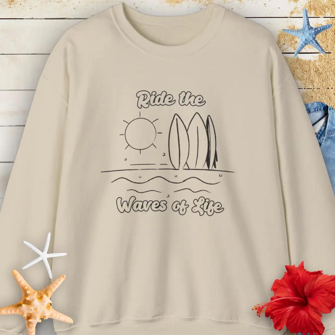 Our Ride the Waves of Life Sweatshirt in Sand with Surfboards and the sun line art with the phrase ide the Waves of Life. Perfect for any surfing enthusiast.