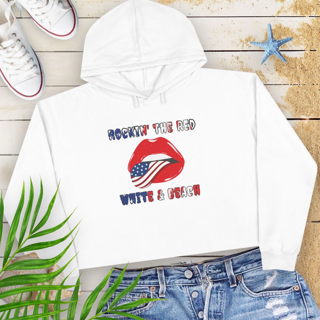 White Rockin' the Beach Crop Hoodie - Patriotic Fashion for Summer Celebrations Hoodie featuring rolling stone lips with an american flag tongue and text that says Rockin' the Red White and Blue that has a gradient of the flag inside.