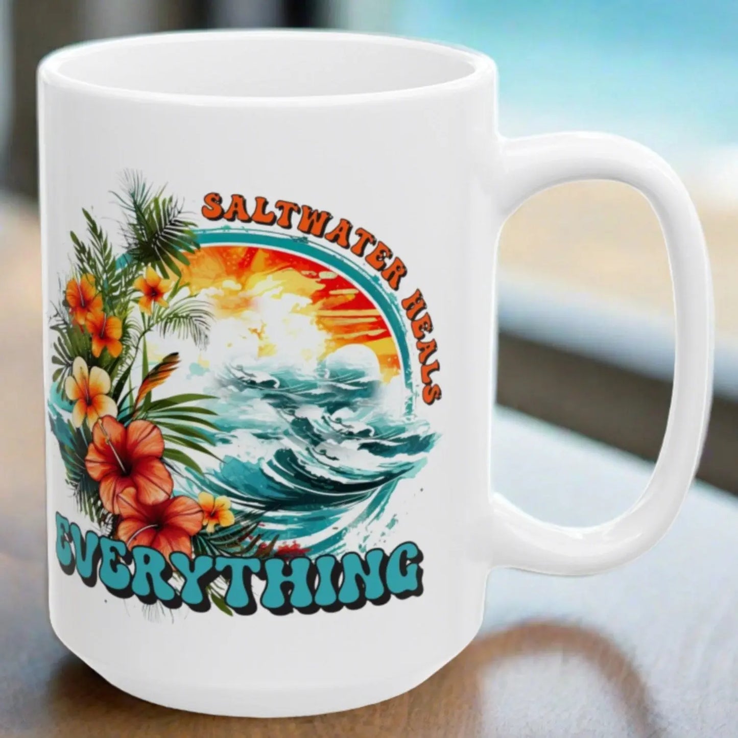 White ceramic 15 oz mug that says Saltwater Heals Everything around ocean waves with tropical flowers
