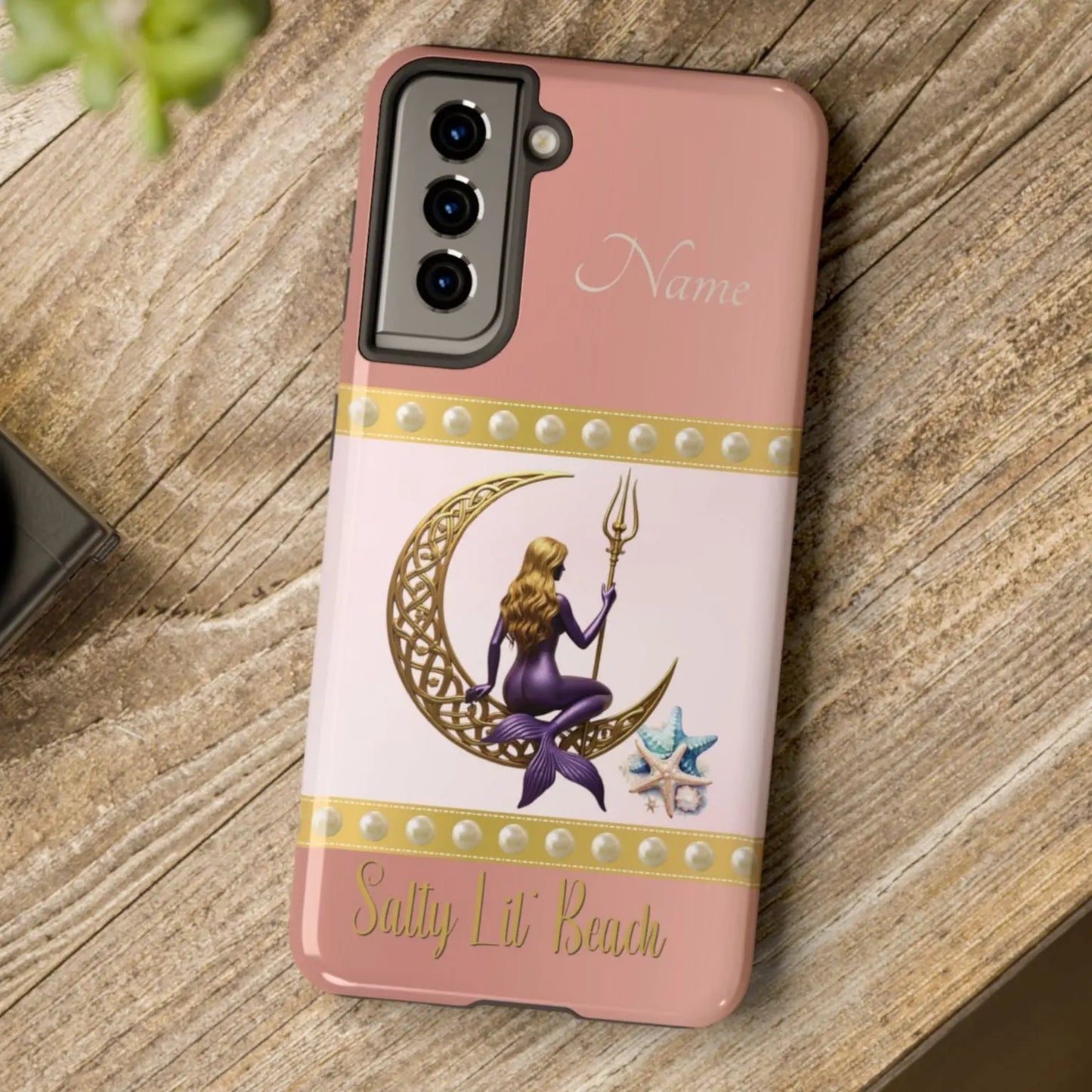 Pink and White Samsung Galaxy S21 Cell Phone Case with mermaid sitting on a celtic crescent moon holding a trident that says Salty Lil' Beach. Personalized with name.