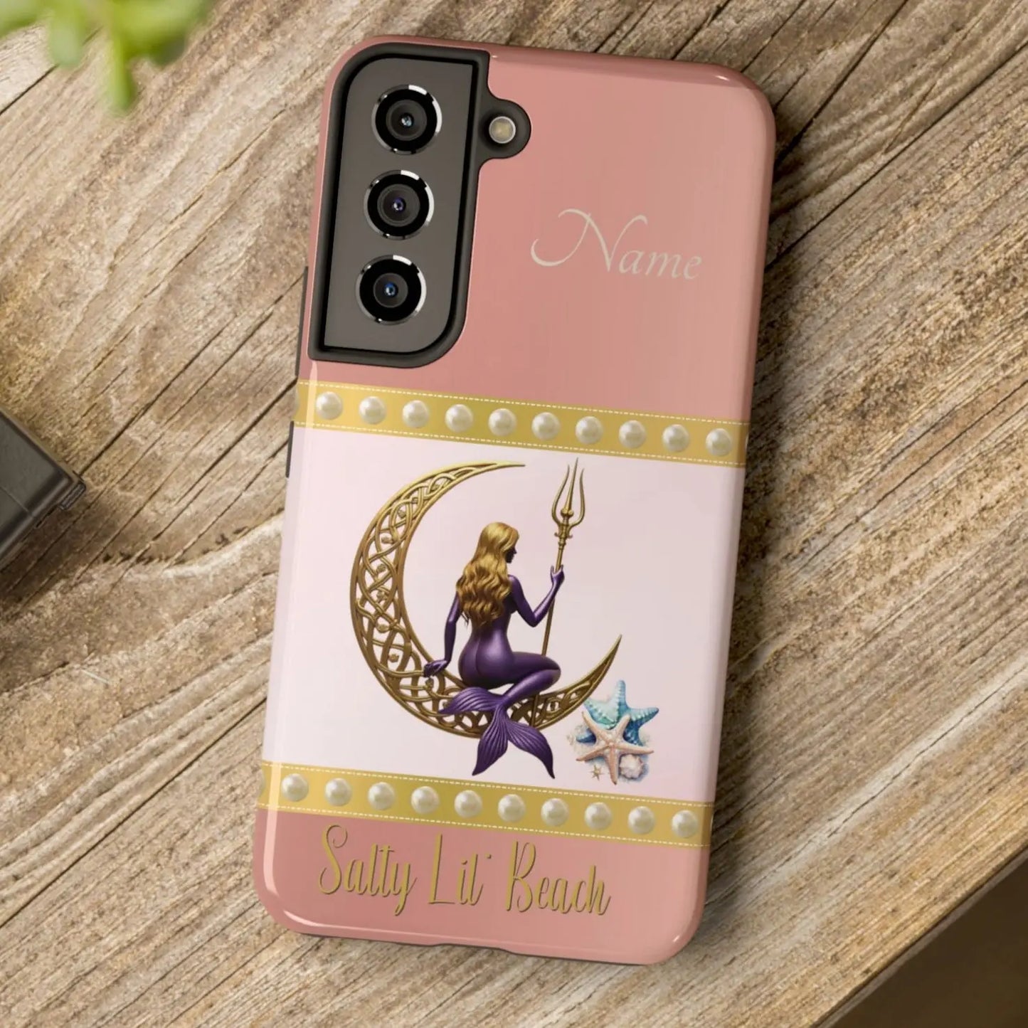 Pink and White Samsung Galaxy S22 Cell Phone Case with mermaid sitting on a celtic crescent moon holding a trident that says Salty Lil' Beach. Personalized with name.