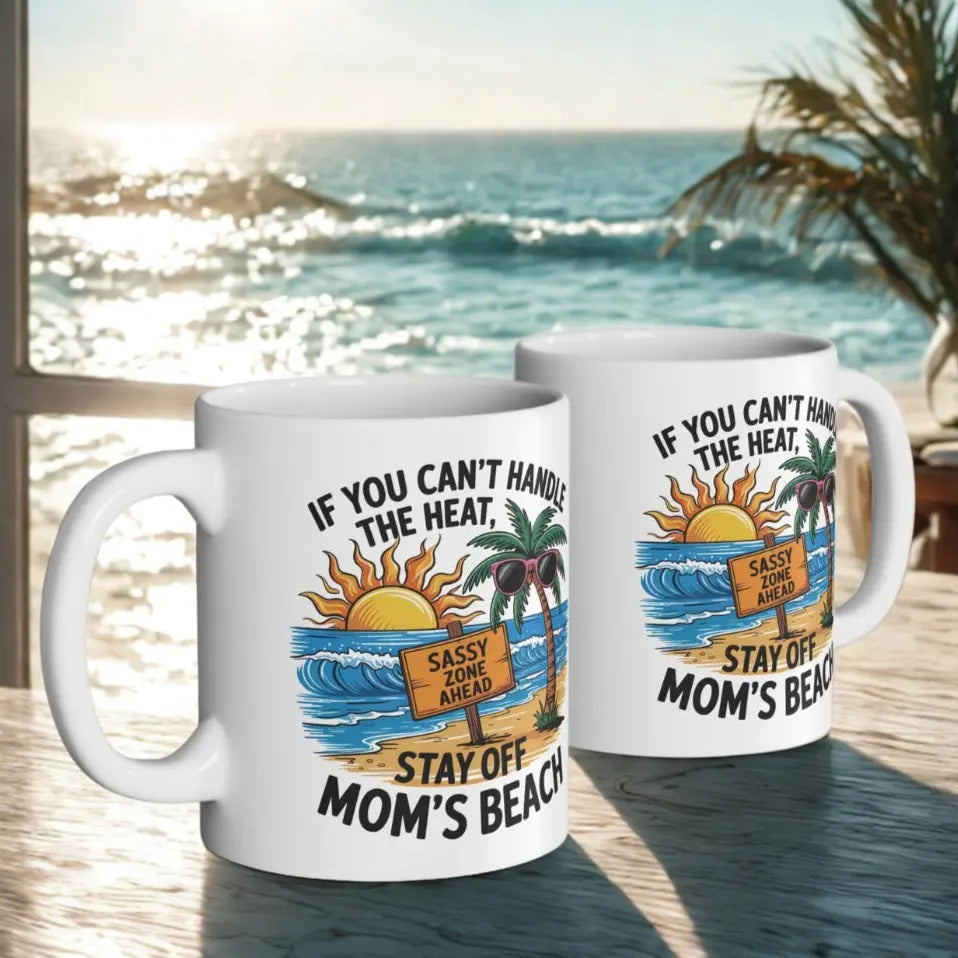 Two white 11 oz mugs with a beach scene and a beach sign that says Sassy Zone Ahead with the text If You Can't Handle the Heat Stay Off Mom's Beach.