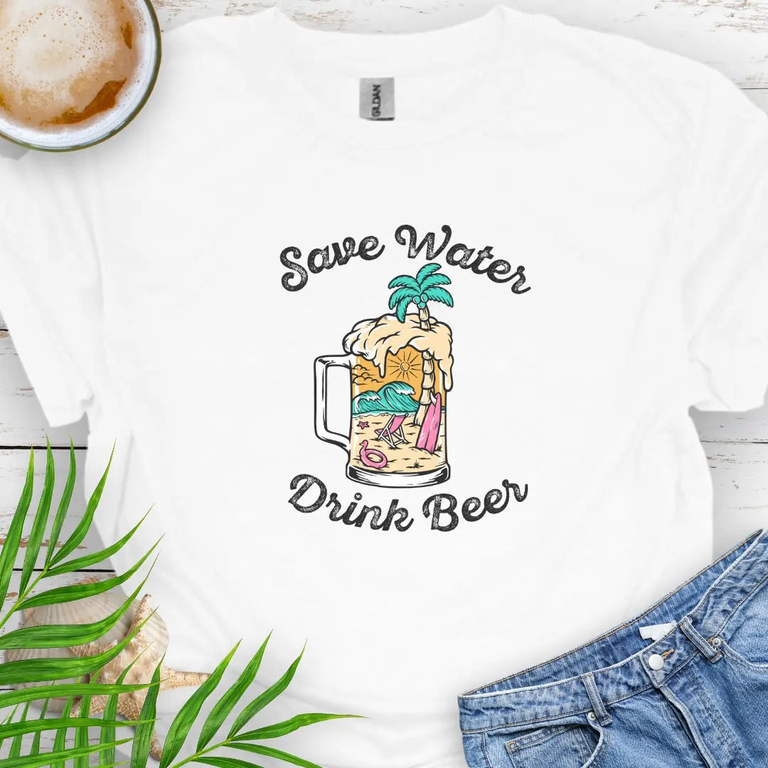 White T-shirt with beer mug filled with an overpour of a beach scene with the text Save Water Drink Beer. Perfect happy hour or party shirt!