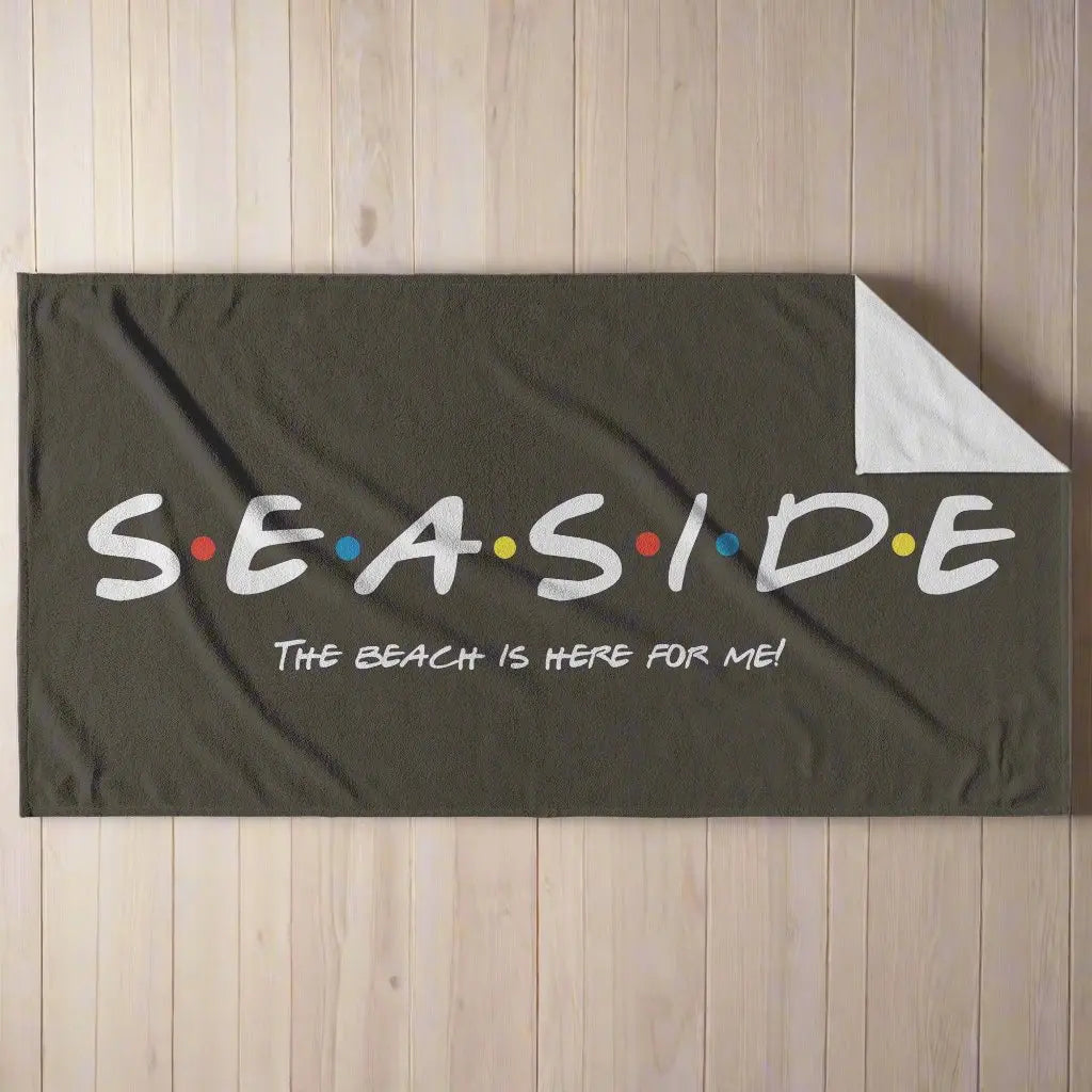 Black beach towel that says Seaside with colored dots in between and says The Beach is Here for Me