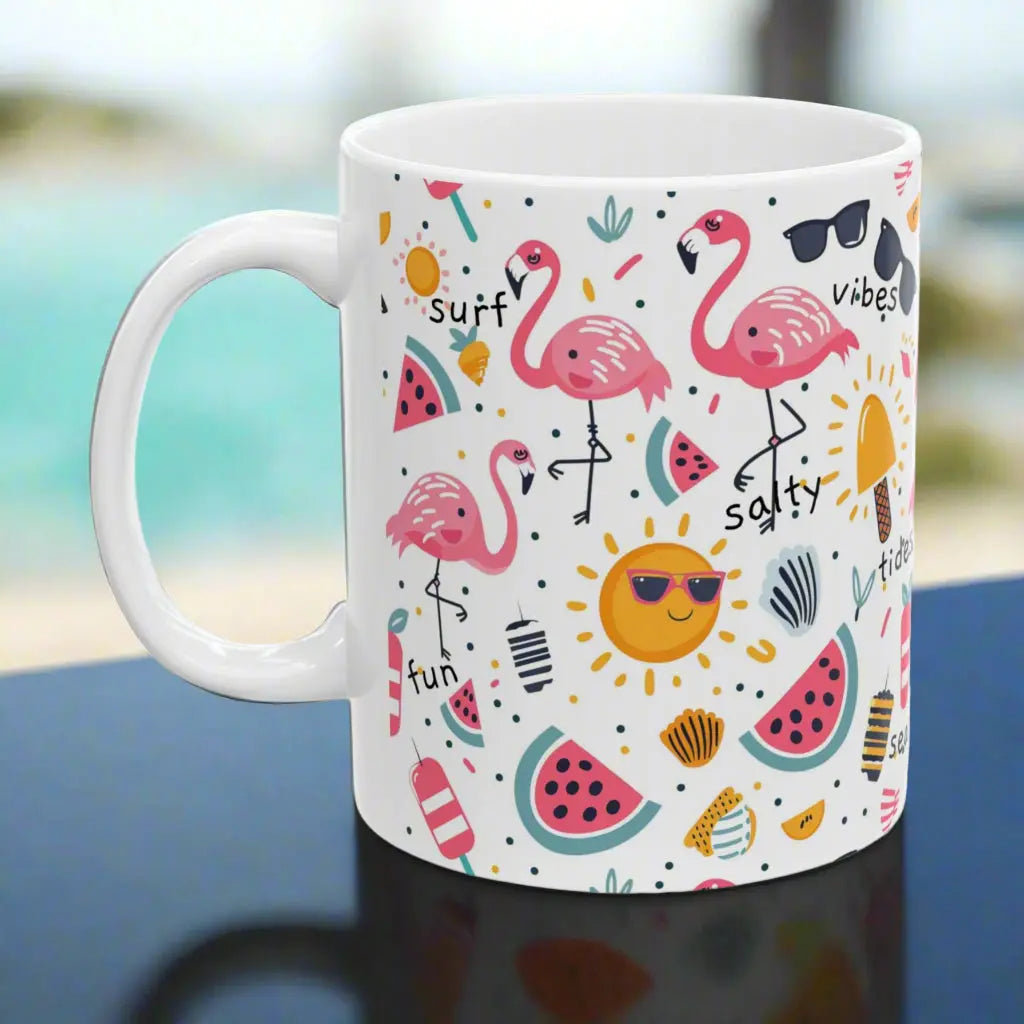 White beach-themed 11 oz coffee mug with colorful fun designs featuring flamingos, watermelon slices, sun, and popsicles. Perfect summer mug for beach lovers, tropical vibes, and sunny morning coffee.