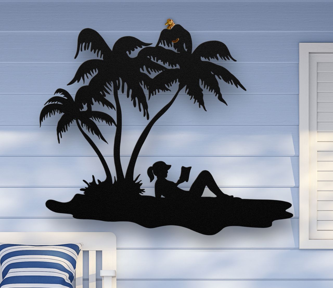 Black Metal wall art of a woman reading under palm trees on the beach, sunbathing in a tropical scene, crafted from steel and available in multiple sizes and colors.