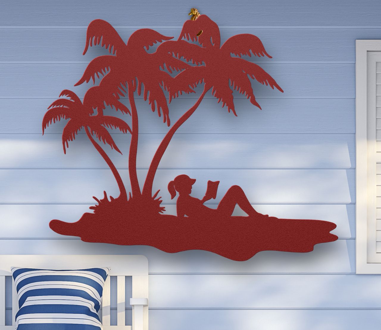 Red Metal wall art of a woman reading under palm trees on the beach, sunbathing in a tropical scene, crafted from steel and available in multiple sizes and colors.