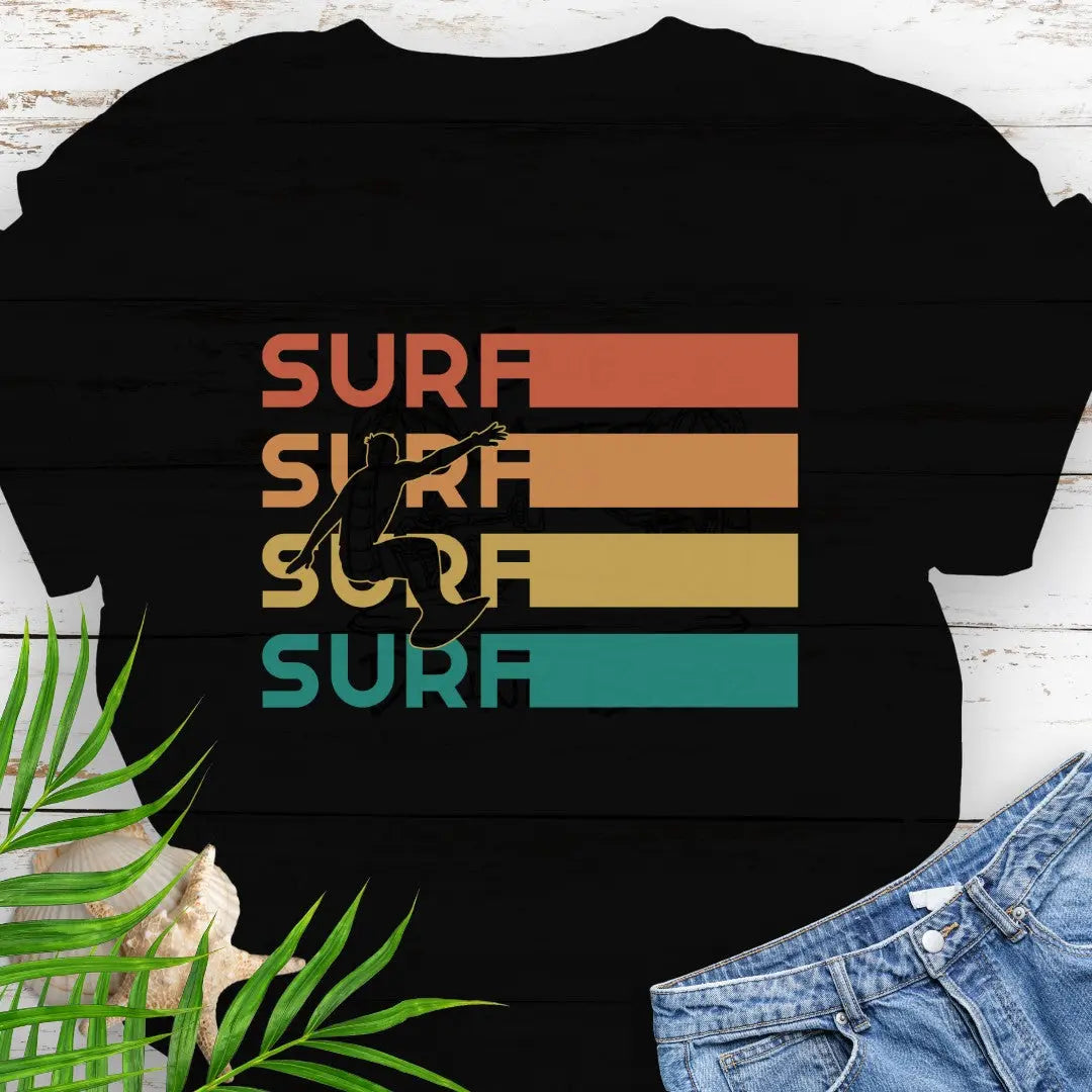 Black T-shirt with silhouette of surfer over four rows that says surf in rainbow colors and extend out in rectangle. Perfect for surfing enthusiasts.