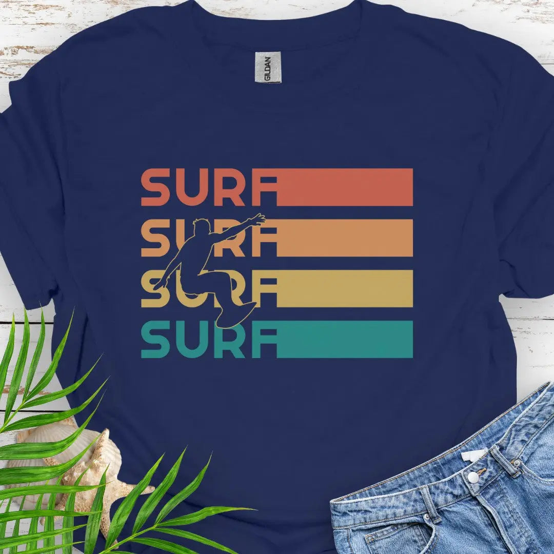 Navy T-shirt with silhouette of surfer over four rows that says surf in rainbow colors and extend out in rectangle. Perfect for surfing enthusiasts.