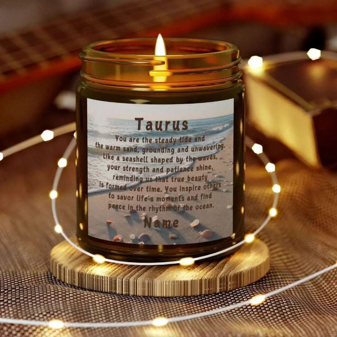 Elegant Taurus Zodiac hand-poured coconut apricot wax scented candle in a 9 oz amber glass jar, featuring a scene of the beach with seashells and an inspirational quote personalized. A beach-inspired astrology gift, perfect for relaxation and decor.