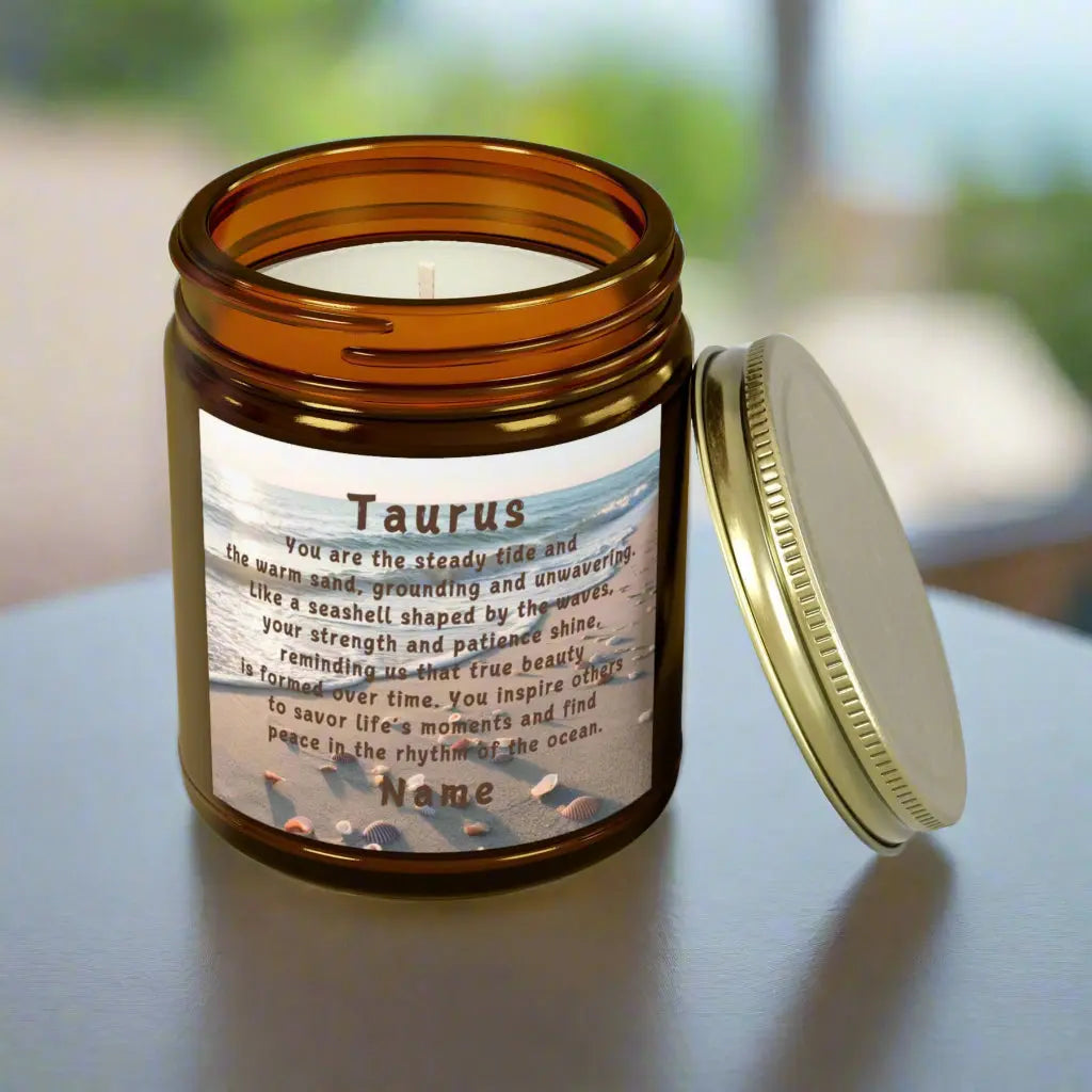 Elegant Taurus Zodiac hand-poured coconut apricot wax scented candle in a 9 oz amber glass jar with gold lid, featuring a scene of the beach with seashells and an inspirational quote personalized. A beach-inspired astrology gift, perfect for relaxation and decor.