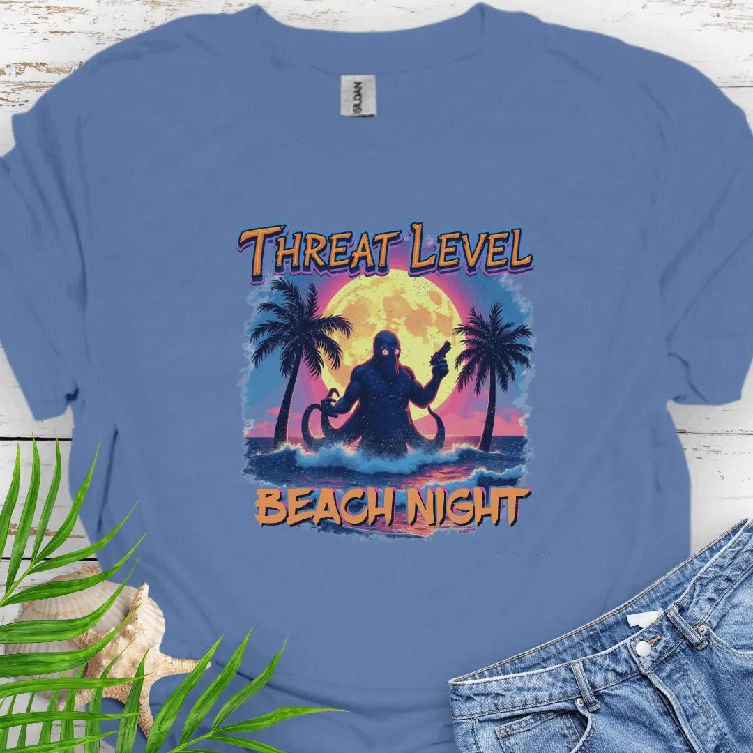 Indigo Blue T-shirt with the words Threat Level Beach Night and an octopus villain coming out of the ocean with a bright moon background in a retro 80's movie poster vibe.