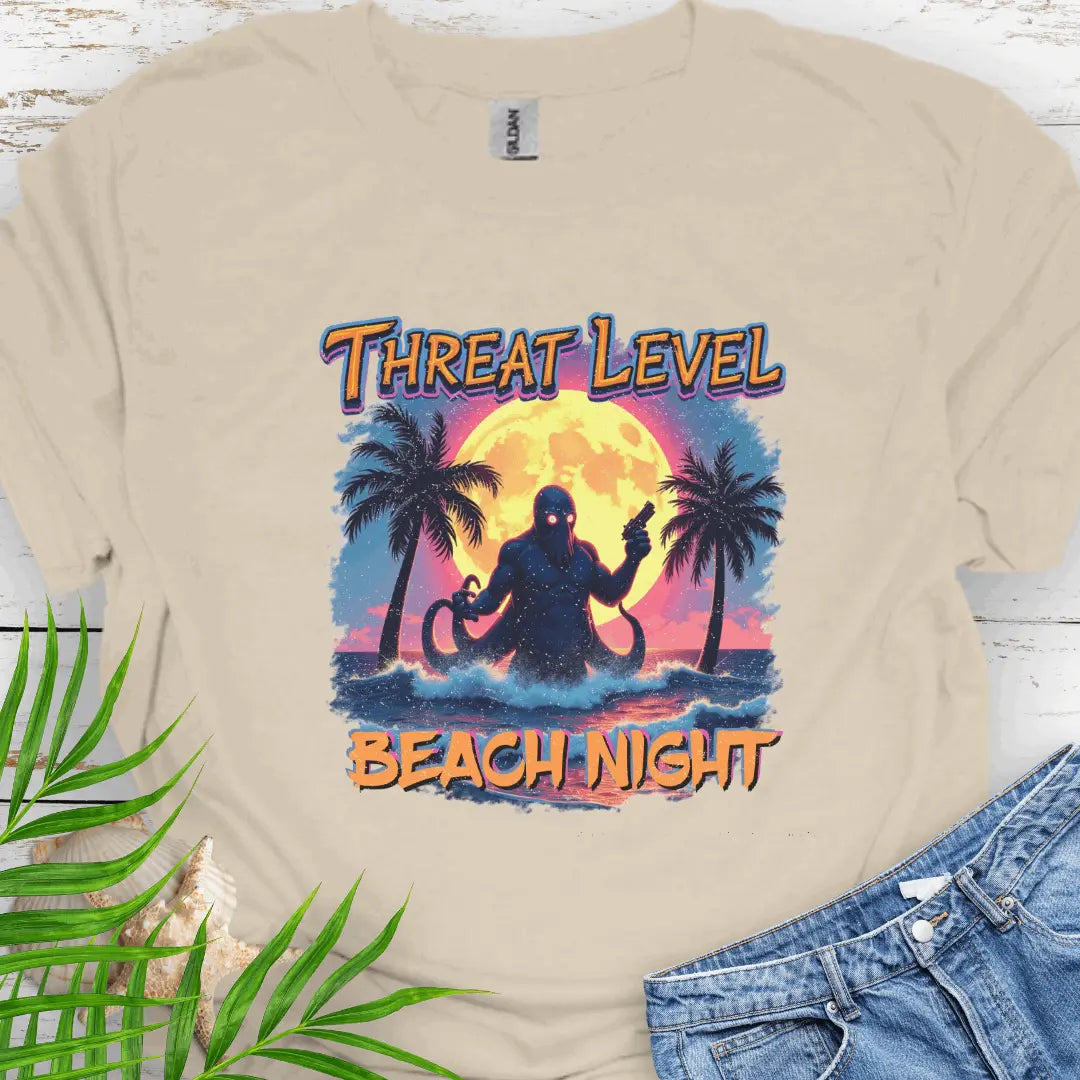 Natural T-shirt with the words Threat Level Beach Night and an octopus villain coming out of the ocean with a bright moon background in a retro 80's movie poster vibe.