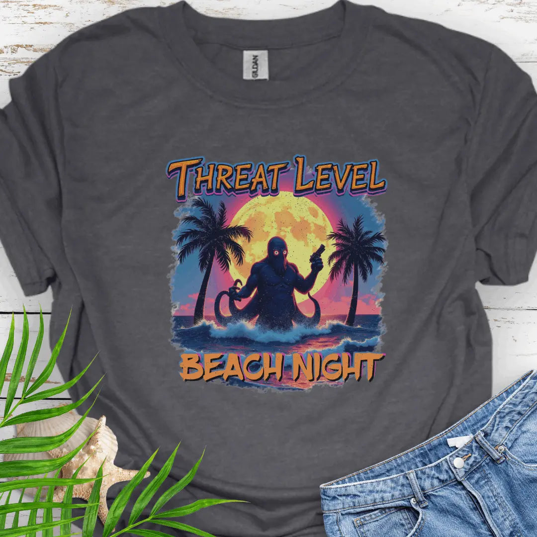 Dark Heather T-shirt with the words Threat Level Beach Night and an octopus villain coming out of the ocean with a bright moon background in a retro 80's movie poster vibe.