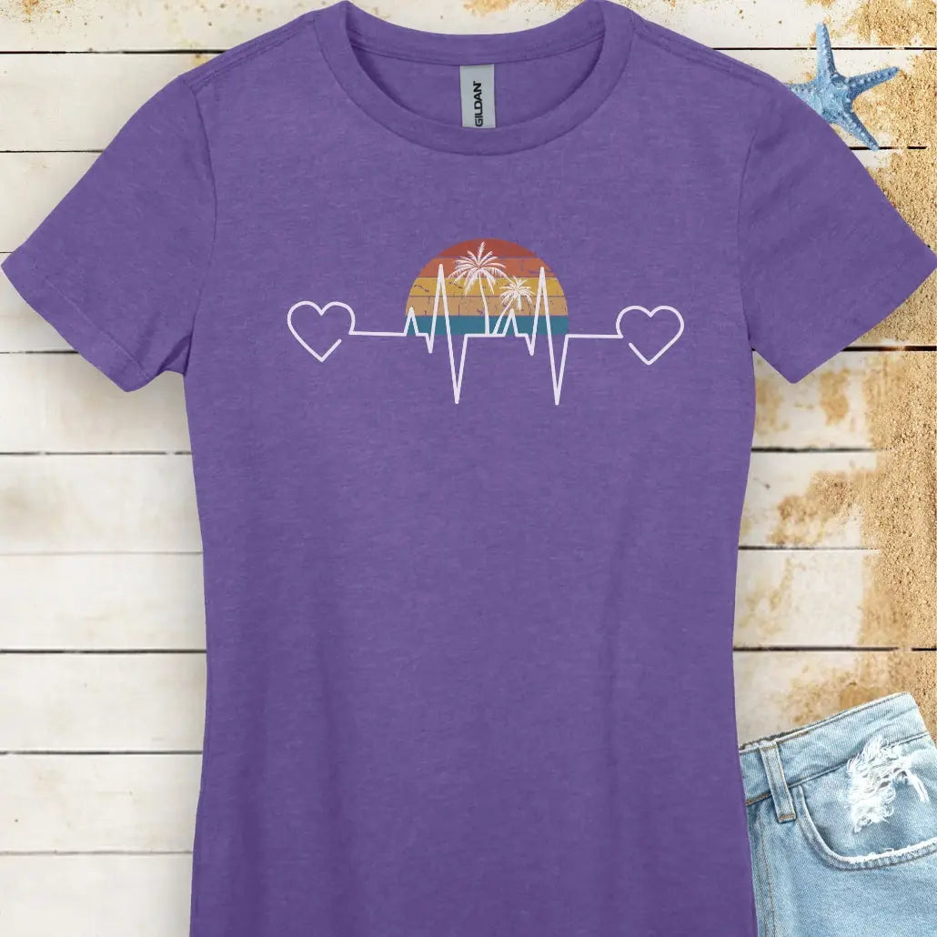 Stay comfy in this heather purple women's T-shirt featuring a retro sunset and heartline design with hearts at both ends. "Tropical Pulse" text adds a beachy, laid-back vibe.
