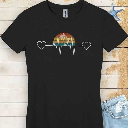 Stay comfy in this black women's T-shirt featuring a retro sunset and heartline design with hearts at both ends. "Tropical Pulse" text adds a beachy, laid-back vibe.