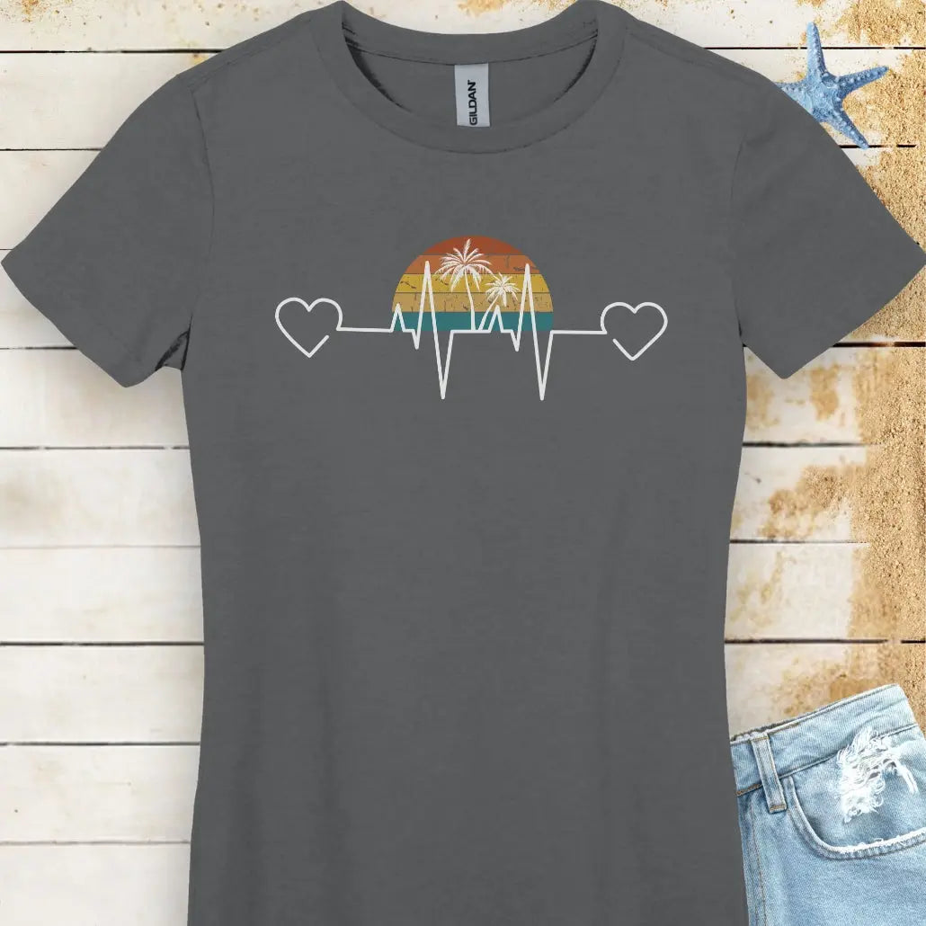 Stay comfy in this charcoal women's T-shirt featuring a retro sunset and heartline design with hearts at both ends. "Tropical Pulse" text adds a beachy, laid-back vibe.