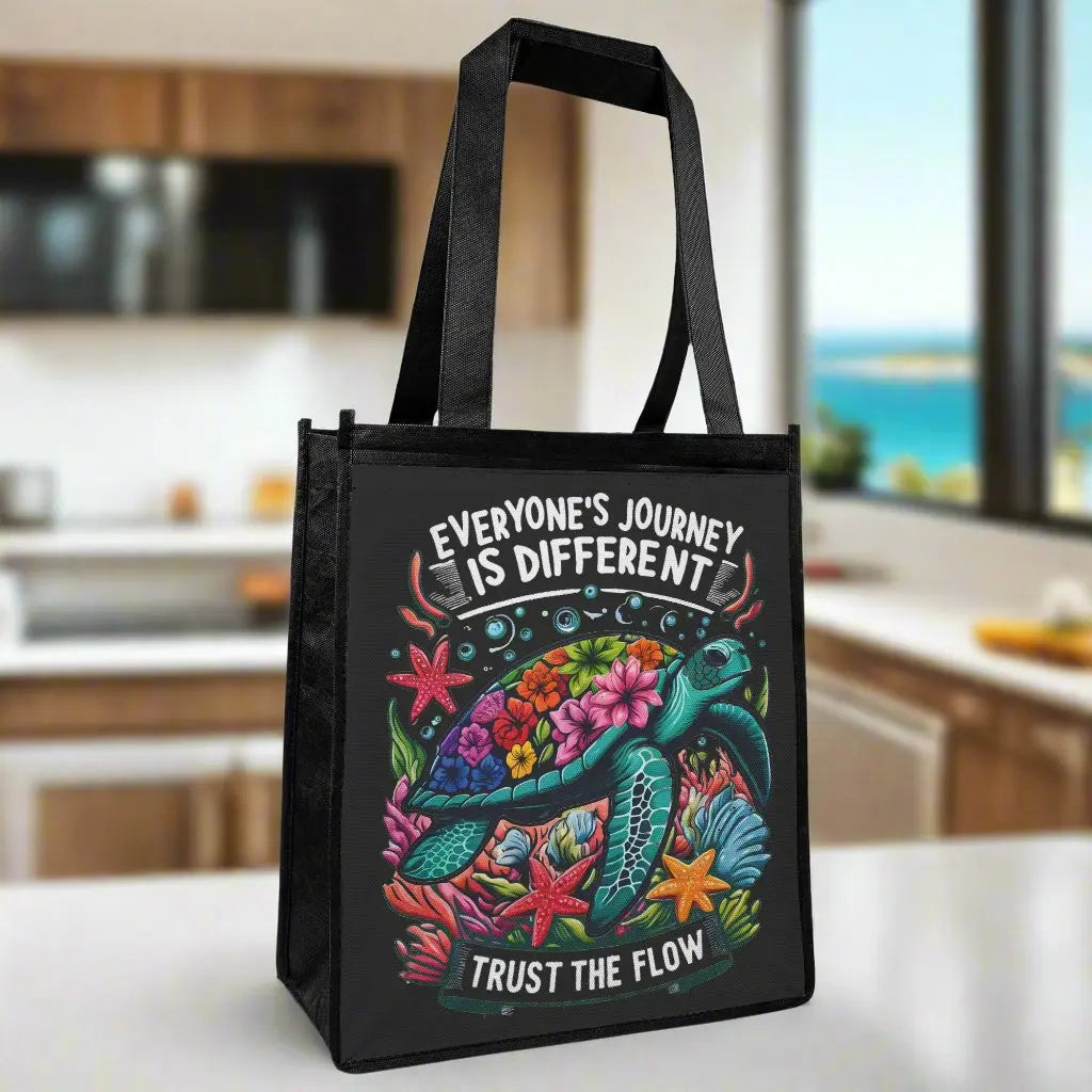 Eco-friendly black grocery tote bag with a vibrant sea turtle design and “Trust the Flow” message.