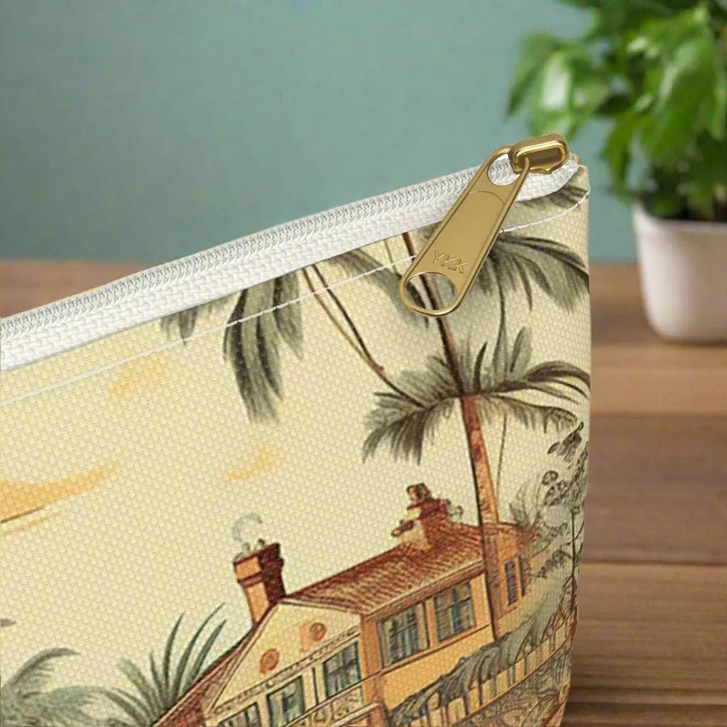 A close-up view of our Vintage Beach Accessory Pouch constructed from a durable material with a zipper closure featuring a vintage beach scene. Available in small or large.