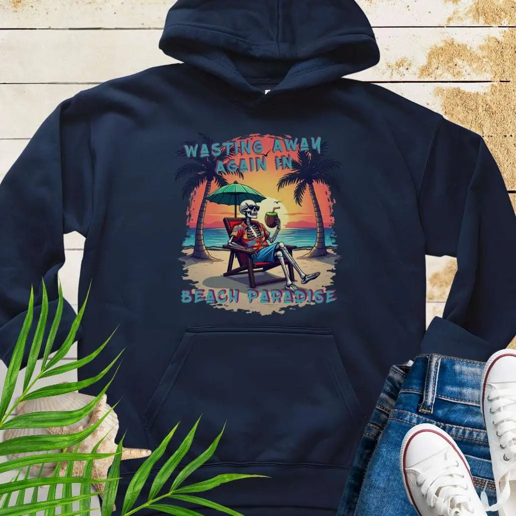 A Navy Hoodie with a skeleton in a Hawaiian Shirt sitting under a beach umbrella on the beach at sunset with a coconut drink between two palm trees that says Wasting Away in Beach Paradise.