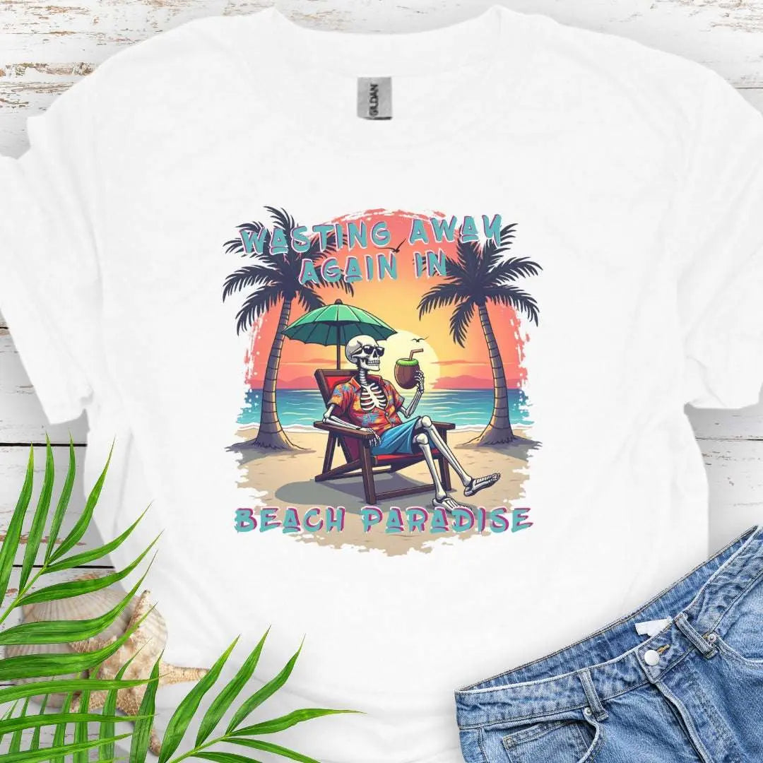A White T-shirt with a skeleton in a Hawaiian Shirt sitting under a beach umbrella on the beach at sunset with a coconut drink between two palm trees that says Wasting Away in Beach Paradise.