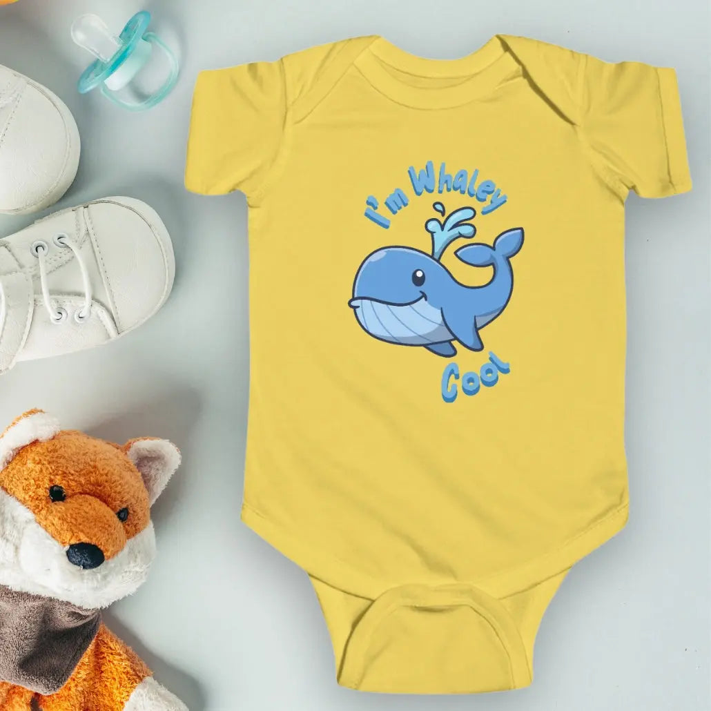 Butter Yellow infant one-piece bodysuit with a cartoon whale that says I'm Whaley Cool.