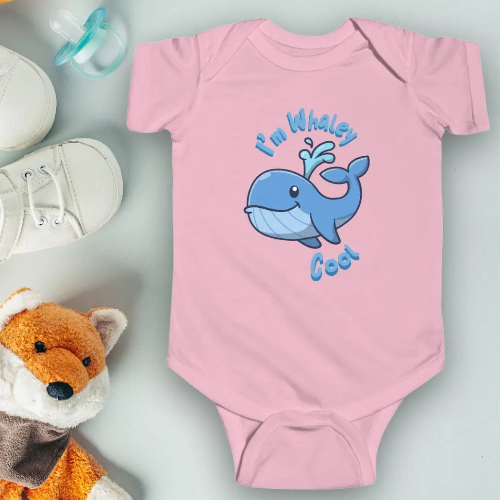 Pink infant one-piece bodysuit with a cartoon whale that says I'm Whaley Cool.