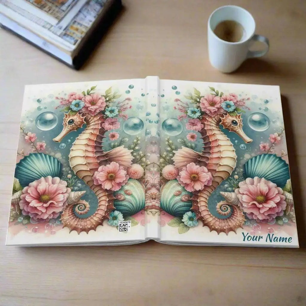 Our hardcover journal brings a touch of ocean magic with a beautifully designed seahorse surrounded by soft, dreamy aqua and pink flowers, bubbles and shells. Perfect for journaling, sketching, or organizing your thoughts, it’s both stylish and durable.