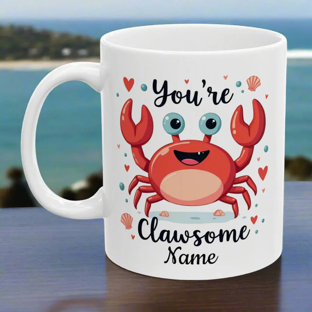White ceramic 11 oz mug with happy crab with text You're Clawsome personalized with recipient name. Ideal for crab lovers, personalized gift seekers, and those looking to add some fun to their daily beverage enjoyment.