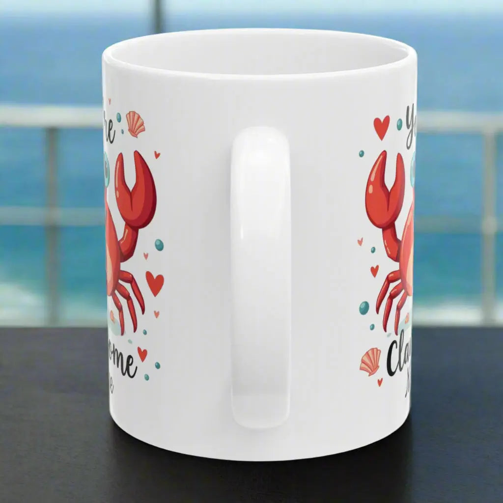 Side view of white ceramic 11oz mug with happy crab with text You're Clawsome personalized with recipient name. Ideal for crab lovers, personalized gift seekers, and those looking to add some fun to their daily beverage enjoyment.
