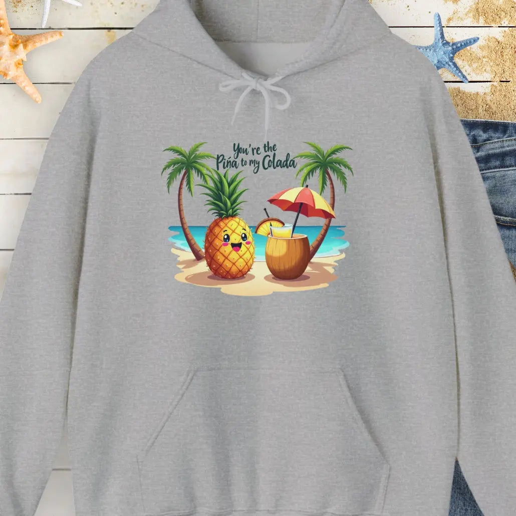 Gray Hoodie with a pineapple and a coconut pina colada on a beach between two palm trees with the text You're the Pina to my Colada.