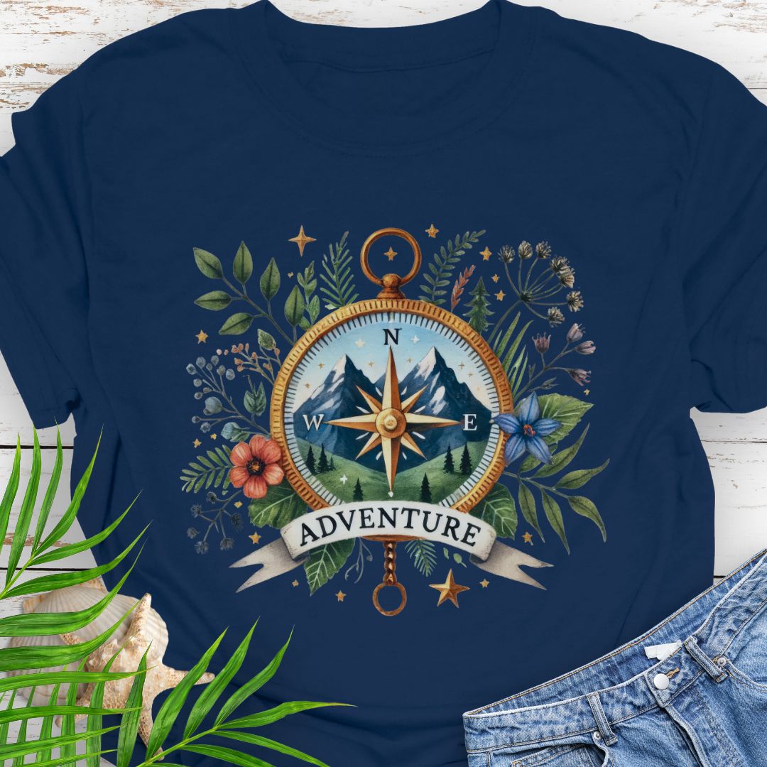 Navy T-shirt with a compass design featuring a mountain scene inside, surrounded by wildflowers and a banner that says "Adventure" – perfect for outdoor enthusiasts.