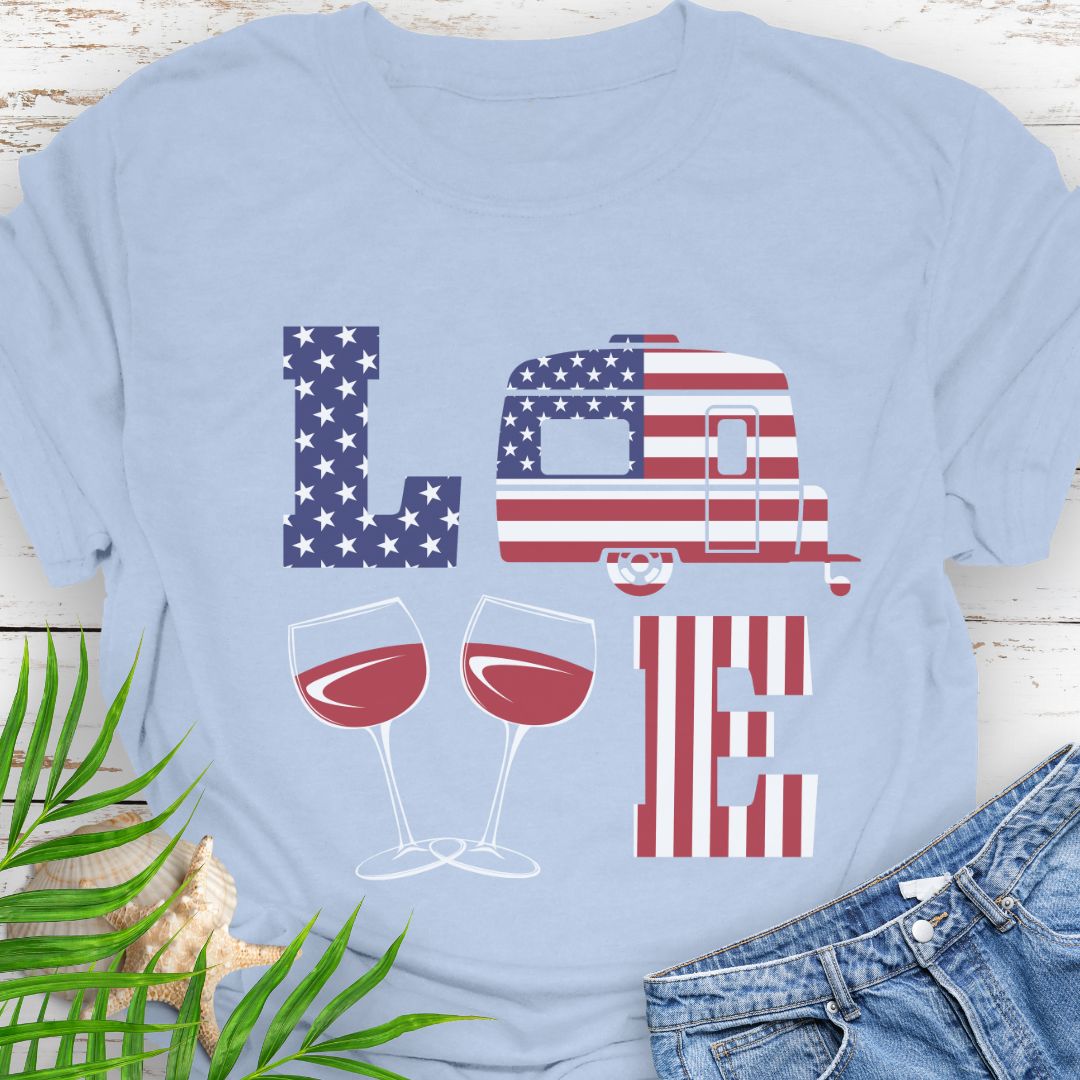 Light blue patriotic LOVE t-shirt design with stars-and-stripes letters, camper, and wine glasses for American-themed camping and wine lovers.