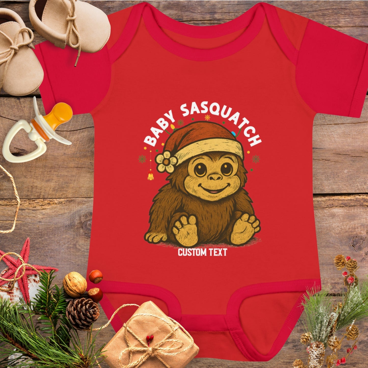 Red baby onesie with 'Baby Sasquatch' design with custom text.