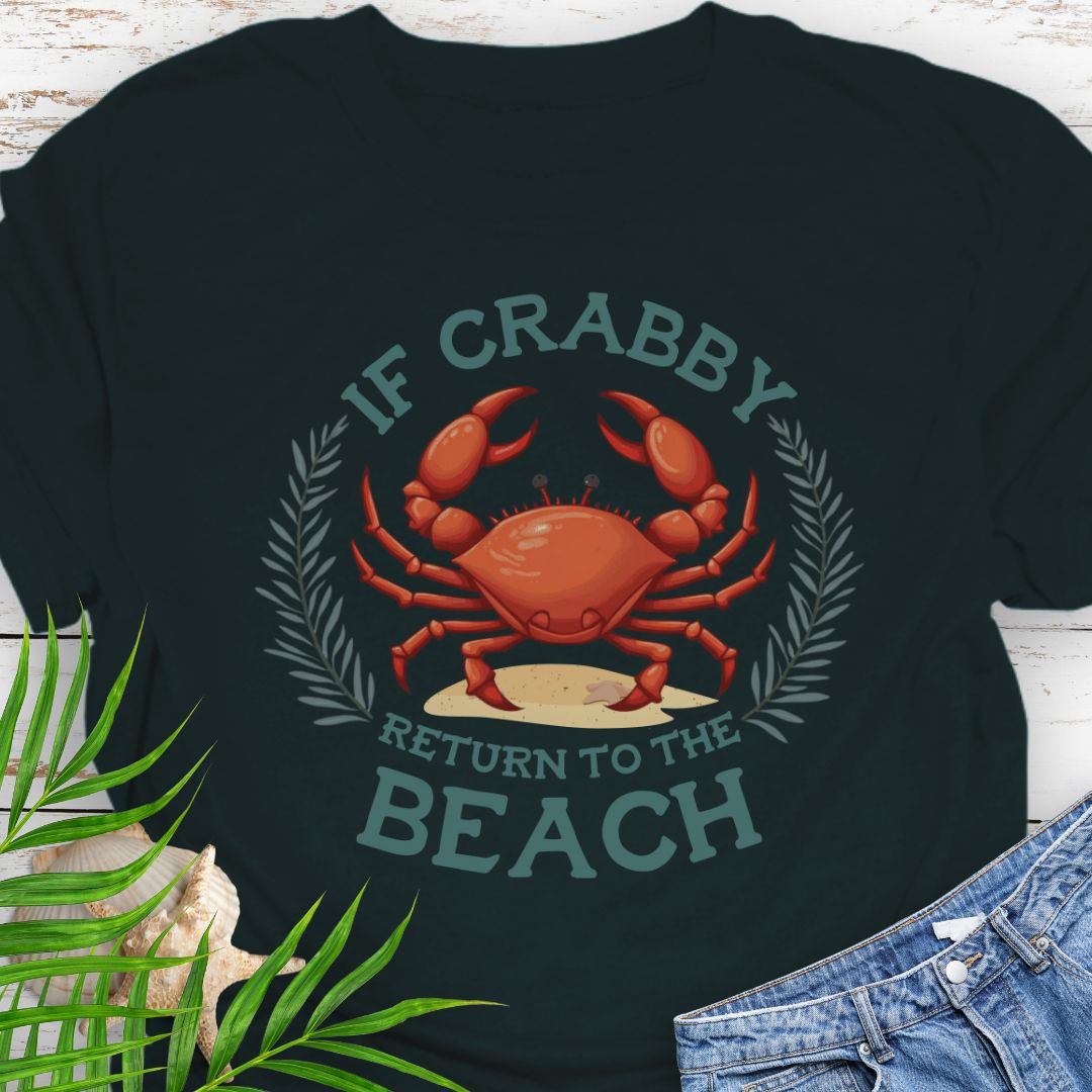 Black t-shirt with a red crab graphic and text 'If Crabby Return to the Beach' on a white wooden surface with greenery.