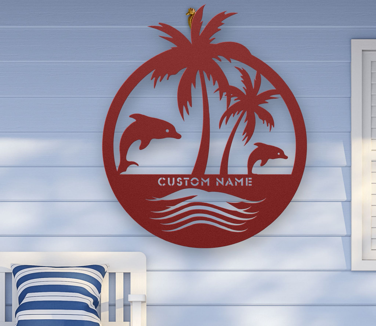 Red custom metal wall art featuring two dolphins jumping near palm trees with space for a family name, established year, or custom phrase in various sizes.