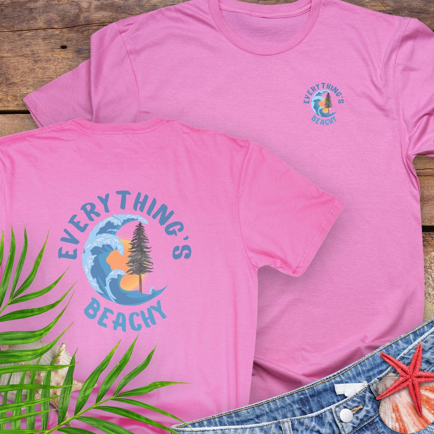 Pink t-shirt with Everything’s Beachy logo with wave, sun, and redwood graphic.