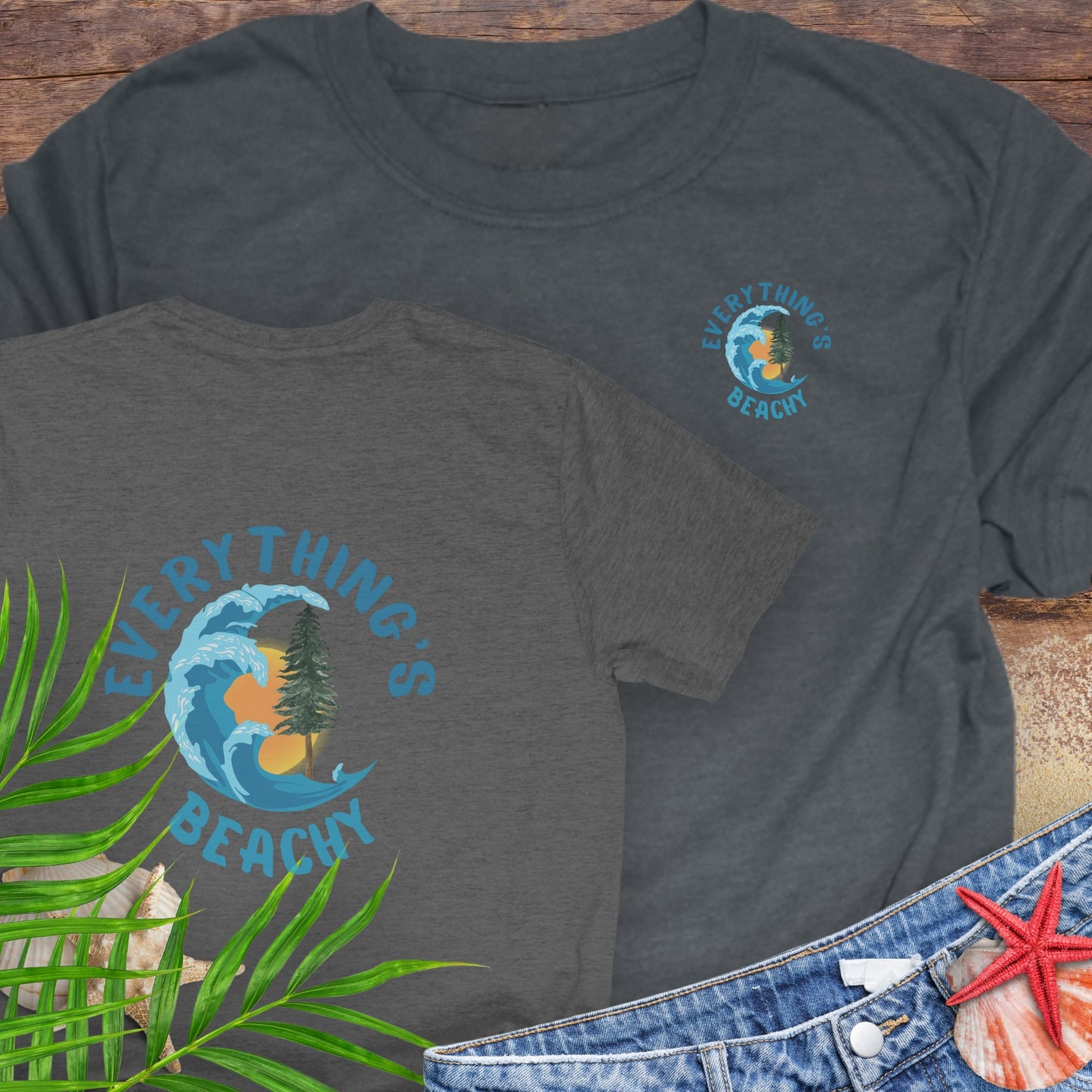 Two dark gray t-shirts with Everything’s Beachy logo with wave, sun, and redwood graphic front and back.