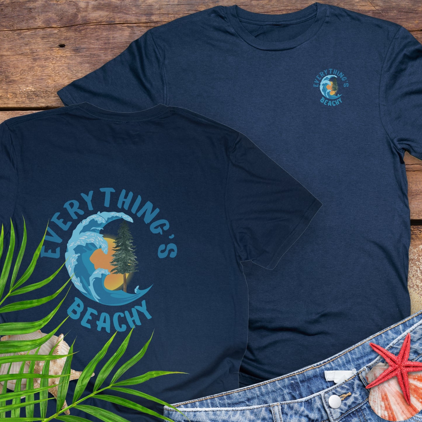 Navy blue t-shirt with Everything’s Beachy logo with wave, sun, and redwood graphic.