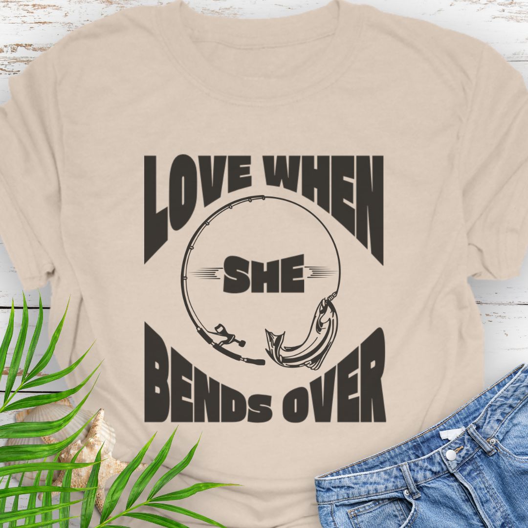 Natural T-shirt with a fishing pole bending over and the phrase “Love When She Bends Over” – humorous fishing design for anglers