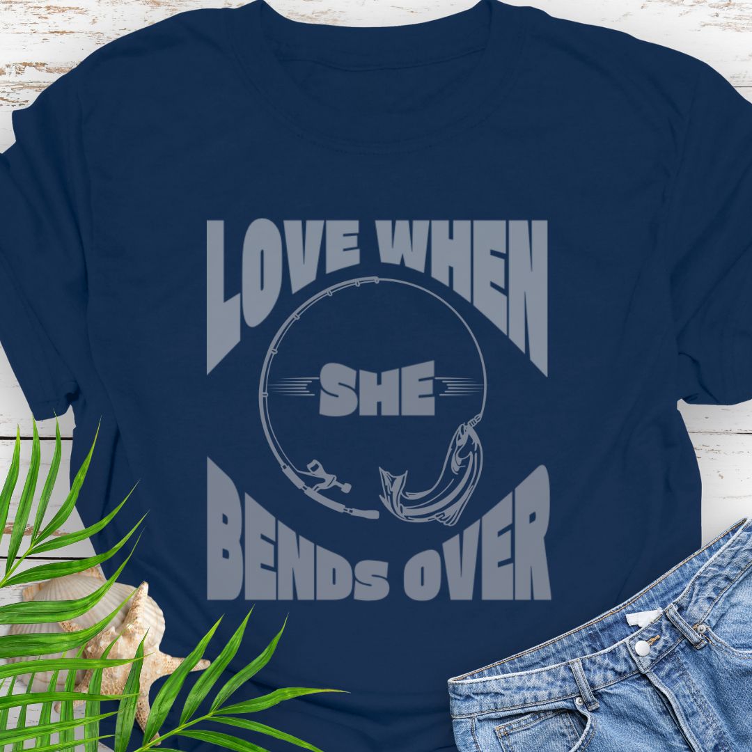 Navy Blue T-shirt with a fishing pole bending over and the phrase “Love When She Bends Over” – humorous fishing design for anglers