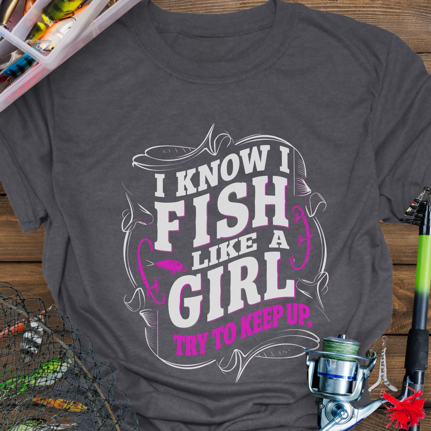 Dark Gray Unisex t-shirt with the phrase “Fish Like a Girl Try to Keep Up” featuring a bold script design and graphic fishing elements.