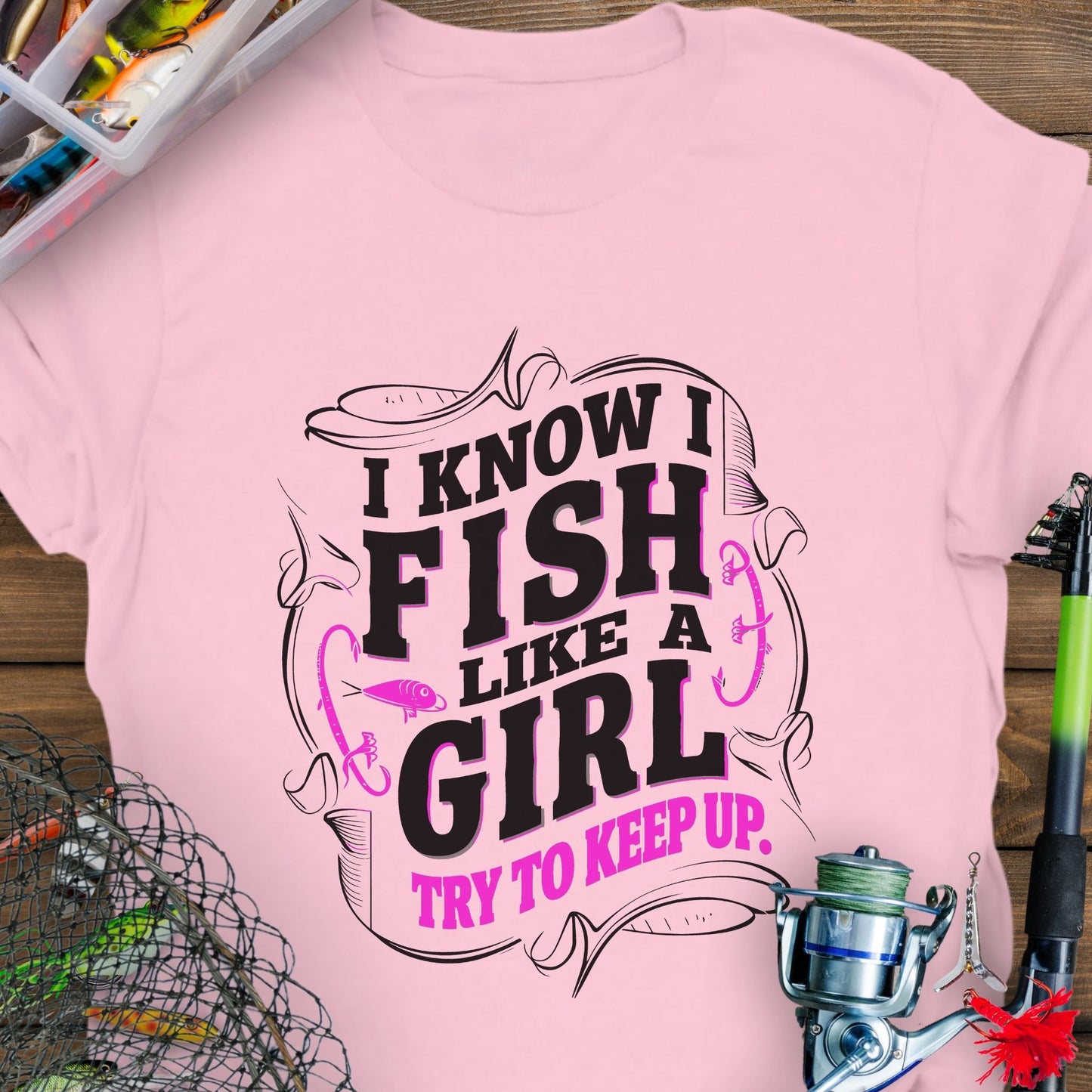 Light Pink Unisex t-shirt with the phrase “Fish Like a Girl Try to Keep Up” featuring a bold script design and graphic fishing elements.