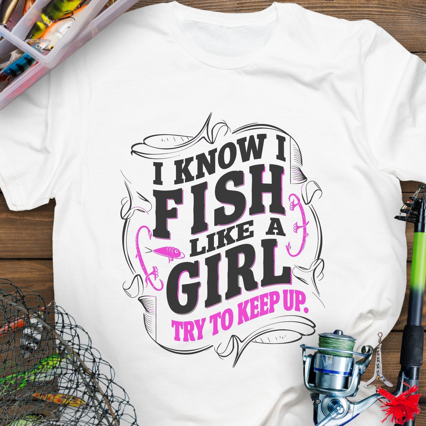 White Unisex t-shirt with the phrase “Fish Like a Girl Try to Keep Up” featuring a bold script design and graphic fishing elements.