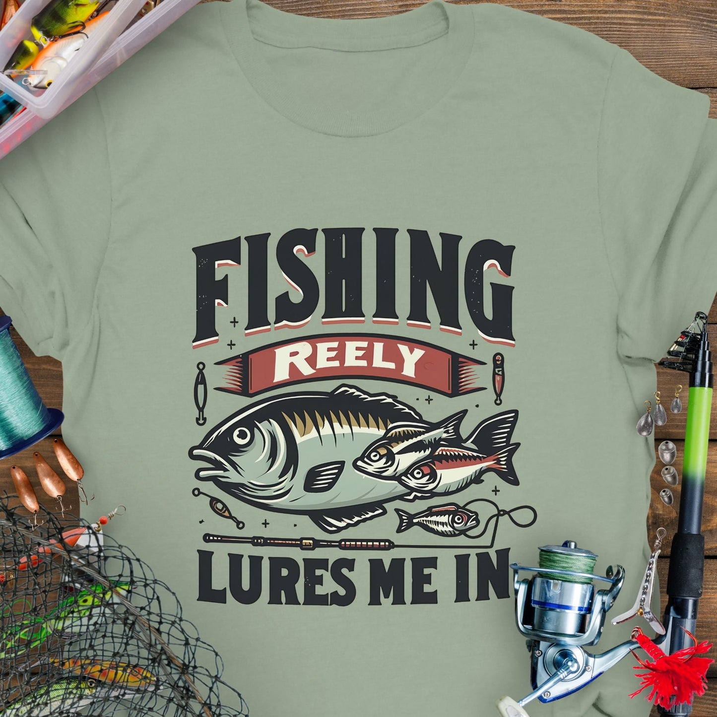 Sage Unisex T-shirt featuring the phrase 'Fishing Reely Lures Me In' with a detailed graphic of a fish and fishing lures. Perfect for anglers and fishing enthusiasts, this comfortable tee is great for casual wear, fishing trips, and outdoor adventures.