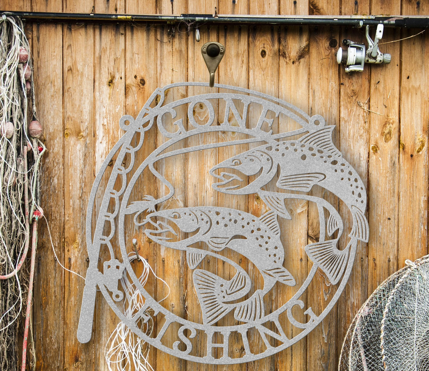 Silver Metal wall art featuring the phrase “Gone Fishing” with a fishing rod and fish silhouette, crafted from steel and available in multiple sizes and finishes.